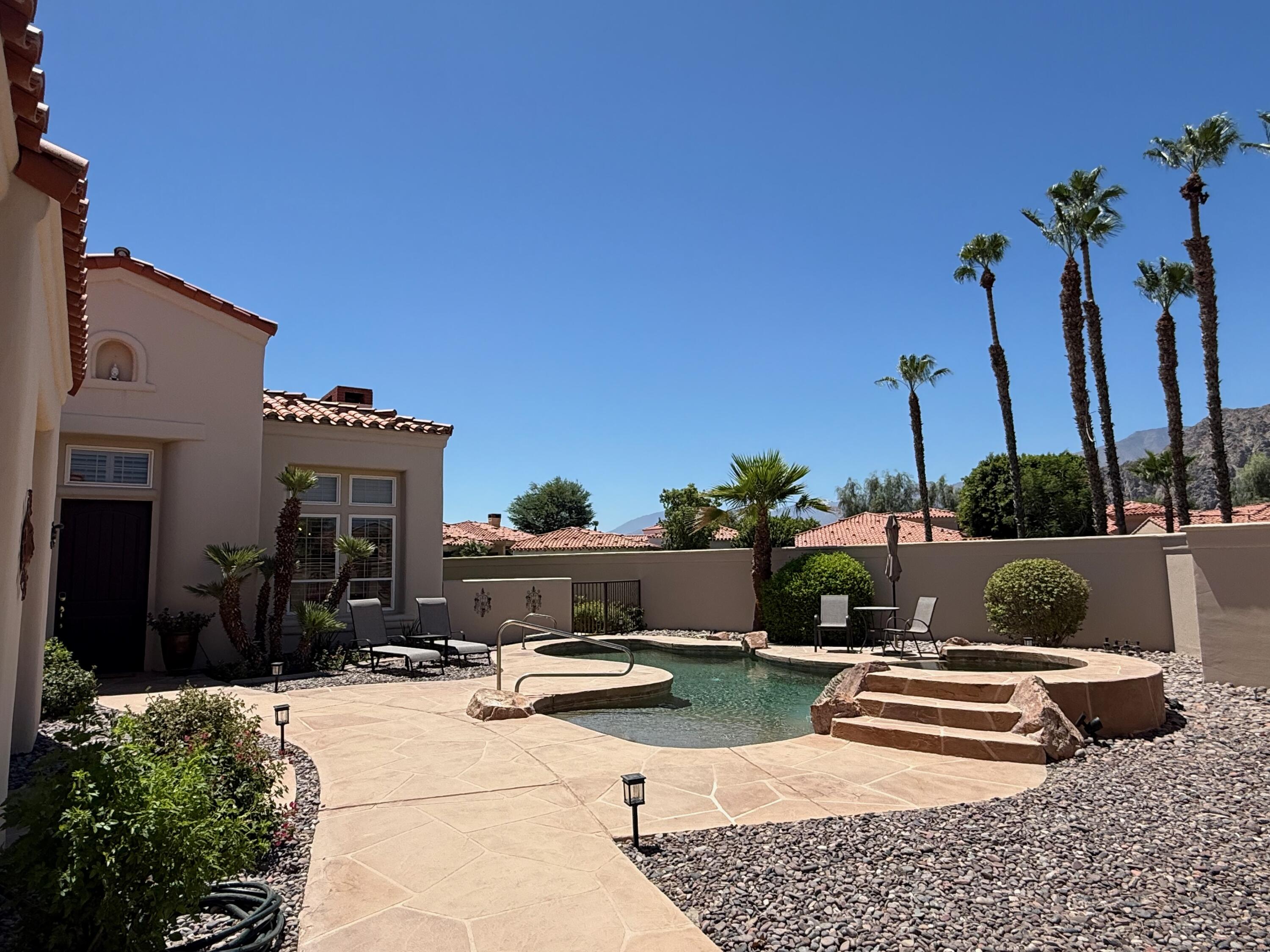 79765 Tangelo La Quinta, CA 92253 - Photo 4 of 55 a front view of a house with a yard