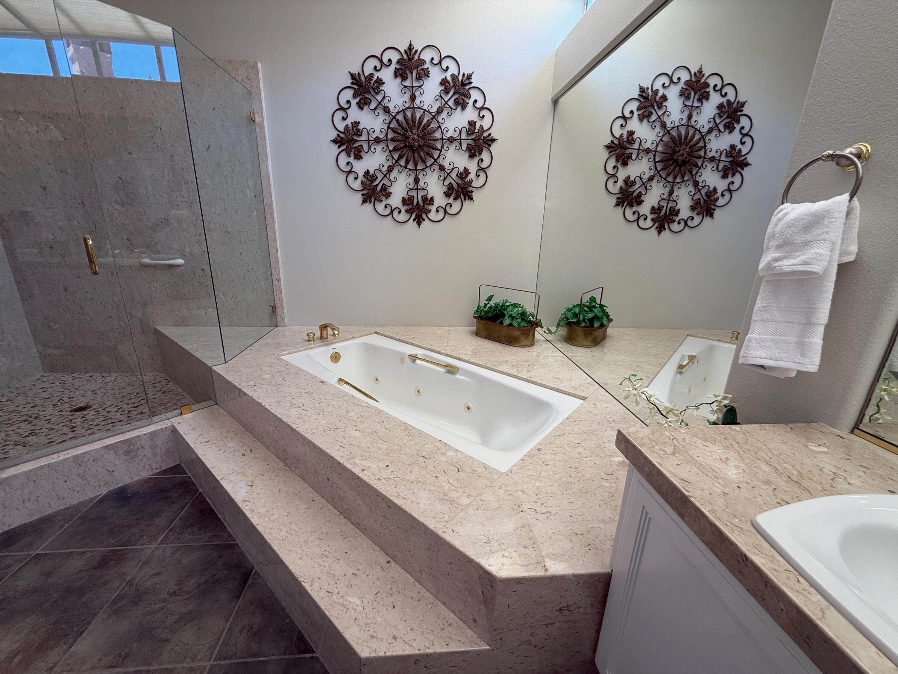 79765 Tangelo La Quinta, CA 92253 - Photo 45 of 55 a bathroom with a granite countertop sink a mirror and vanity