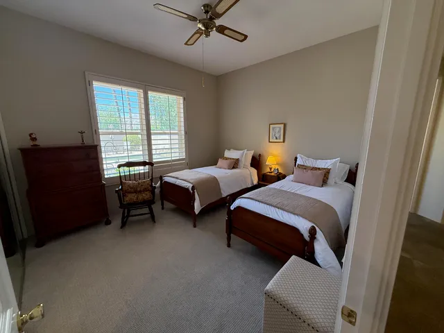 a spacious bedroom with a bed and a window