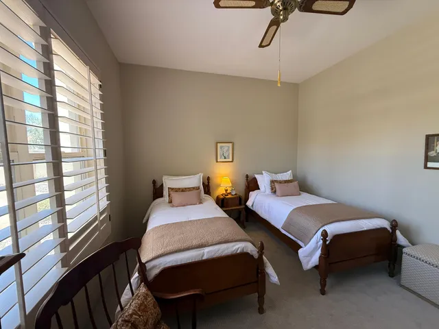 a spacious bedroom with a bed and a chandelier