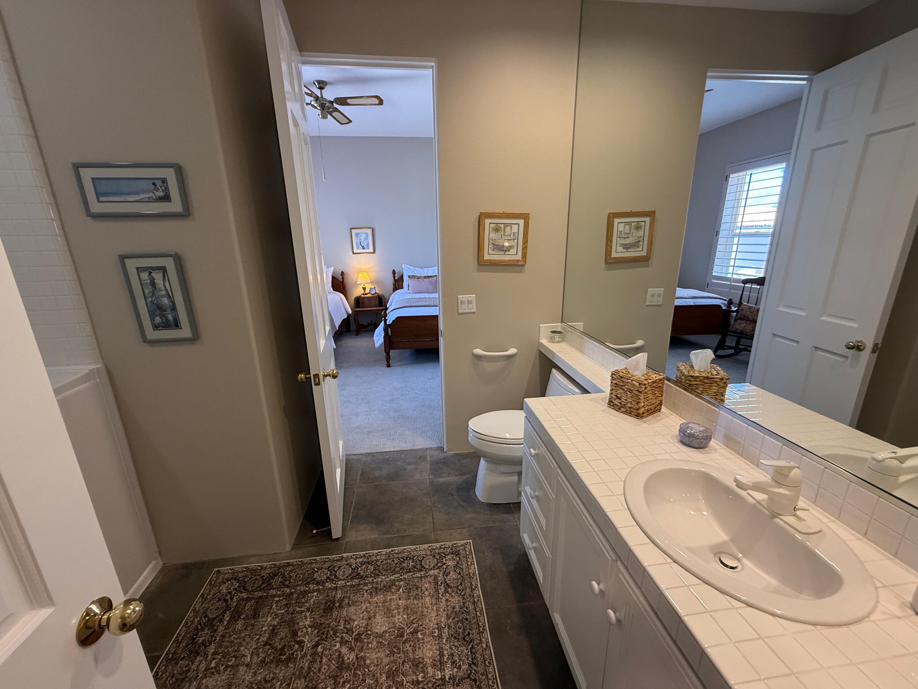 79765 Tangelo La Quinta, CA 92253 - Photo 49 of 55 a bathroom with a sink toilet and mirror
