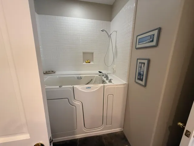 a bathroom with a double vanity sink toilet and shower