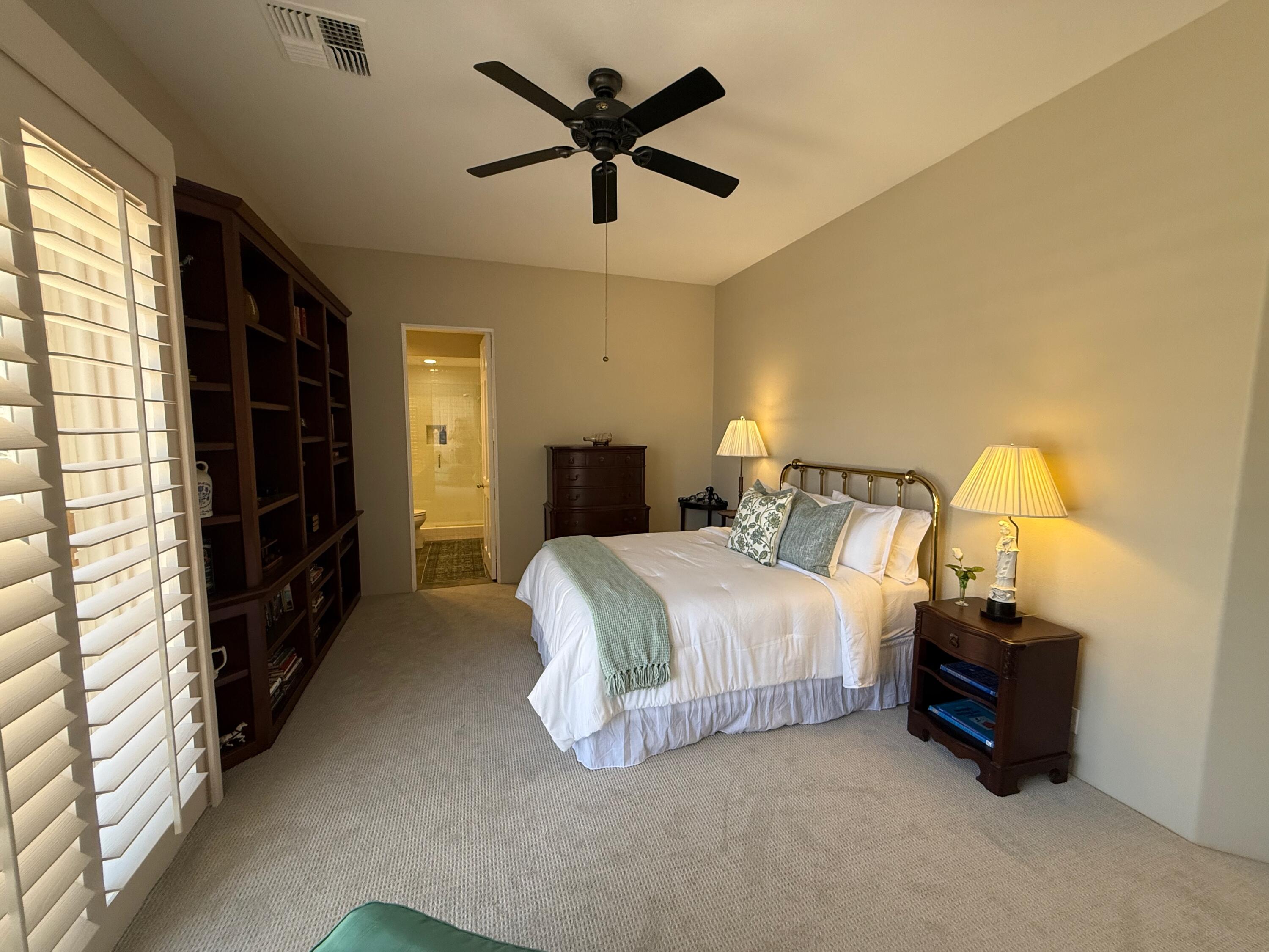 79765 Tangelo La Quinta, CA 92253 - Photo 53 of 55 a spacious bedroom with a bed and a chandelier