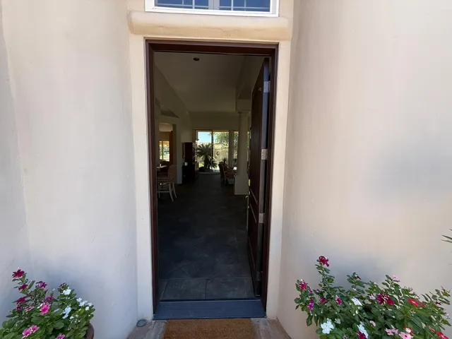 a living room with fireplace furniture and a large window