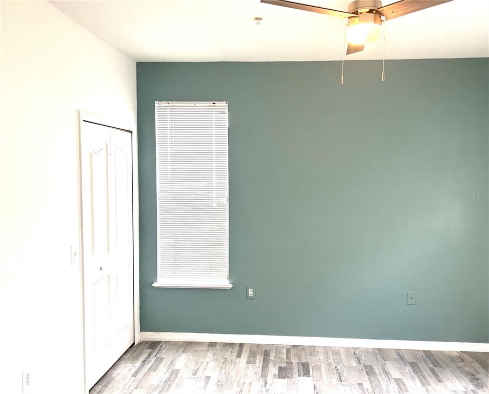 6137 Metrowest Boulevard, Unit 307 Orlando, FL 32835 - Photo 12 of 28 a view of a room with a window and a ceiling fan