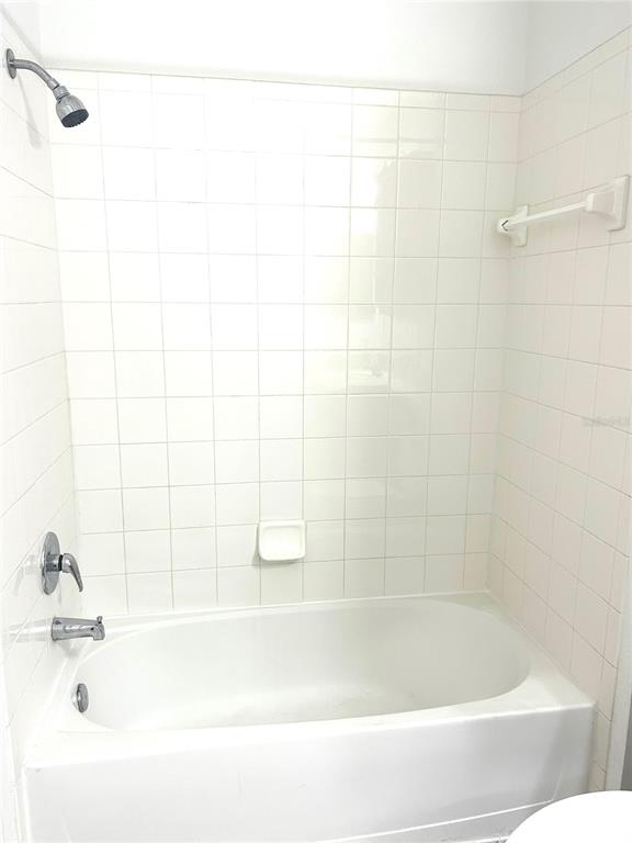 6137 Metrowest Boulevard, Unit 307 Orlando, FL 32835 - Photo 16 of 28 a close up of a bathtub in a bathroom