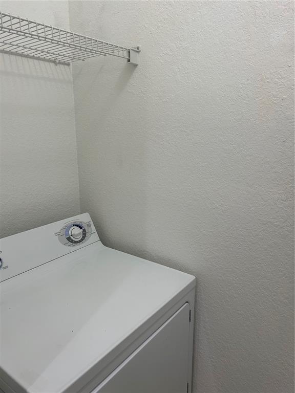 6137 Metrowest Boulevard, Unit 307 Orlando, FL 32835 - Photo 17 of 28 a utility room with dryer and washer