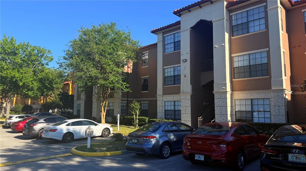 6137 Metrowest Boulevard, Unit 307 Orlando, FL 32835 - Photo 2 of 28 a couple of cars parked in front of a building