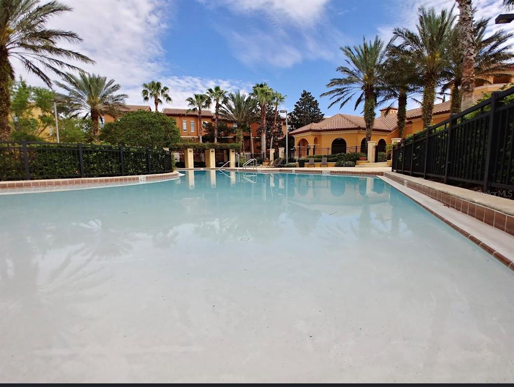 6137 Metrowest Boulevard, Unit 307 Orlando, FL 32835 - Photo 22 of 28 a front view of a house with a yard and a swimming pool