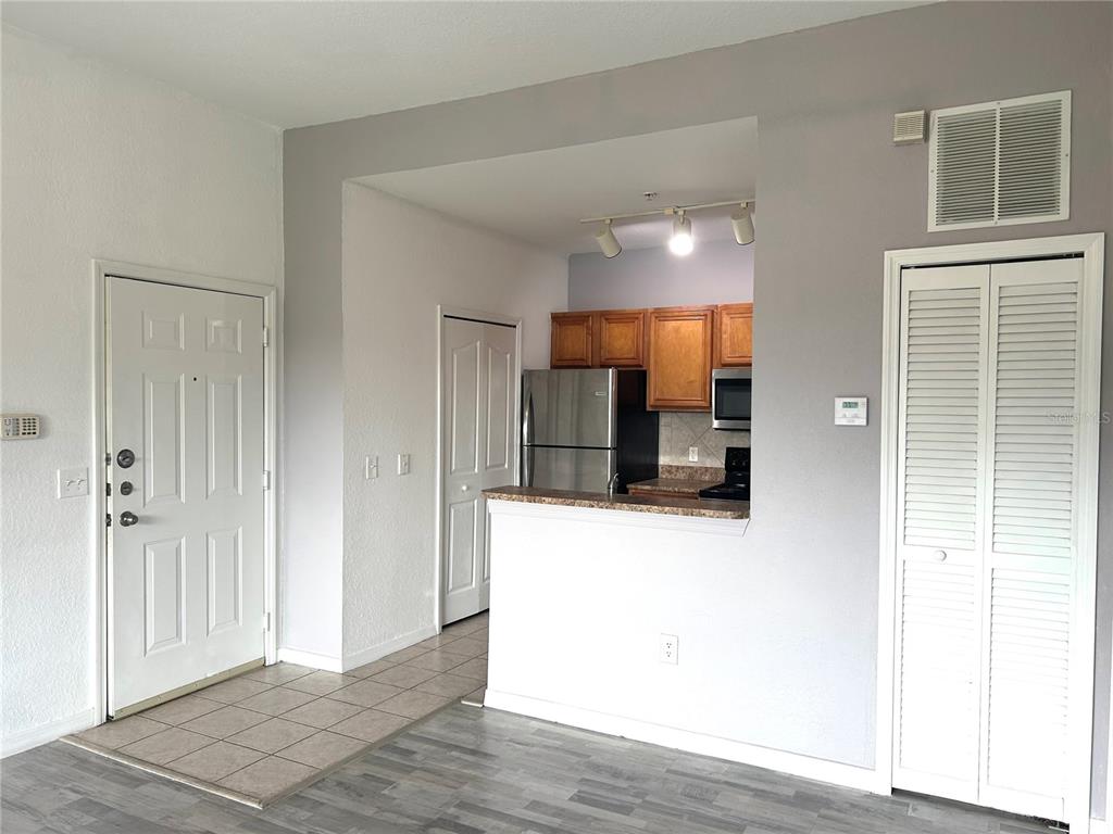 6137 Metrowest Boulevard, Unit 307 Orlando, FL 32835 - Photo 8 of 28 a view of a kitchen from the hallway