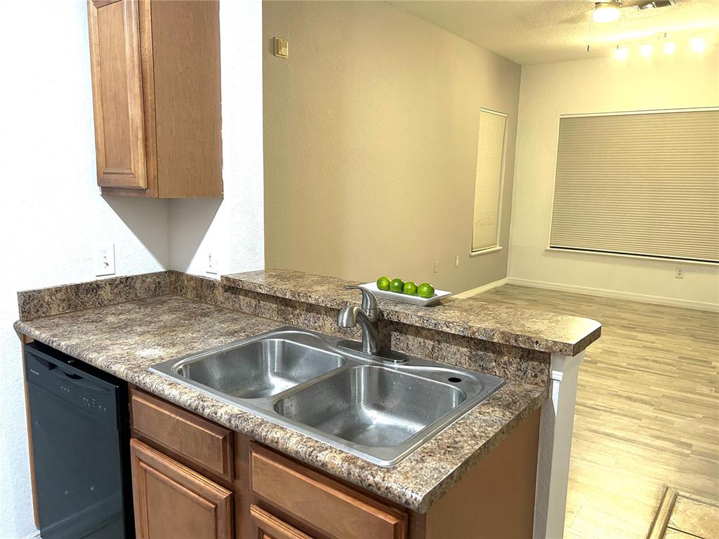 6137 Metrowest Boulevard, Unit 307 Orlando, FL 32835 - Photo 10 of 28 a kitchen with a sink and a granite counter tops