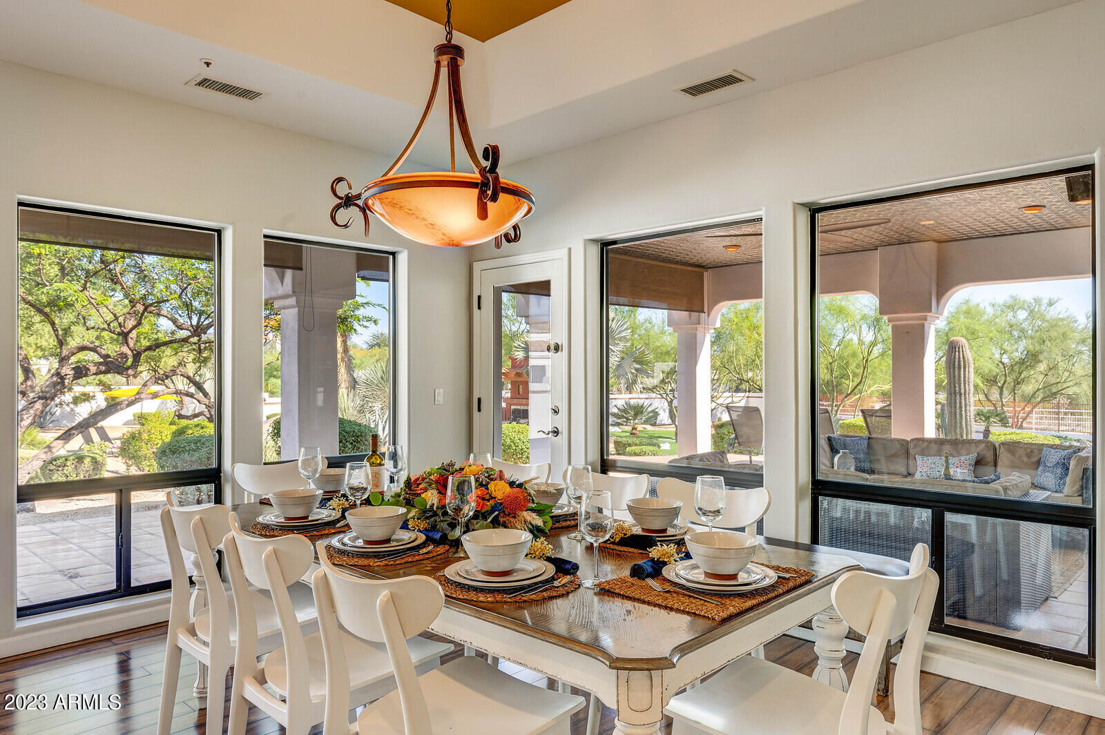 8161 East Alameda Road Scottsdale, AZ 85255 - Photo 14 of 107 a view of a dining room and livingroom with furniture wooden floor a chandelier