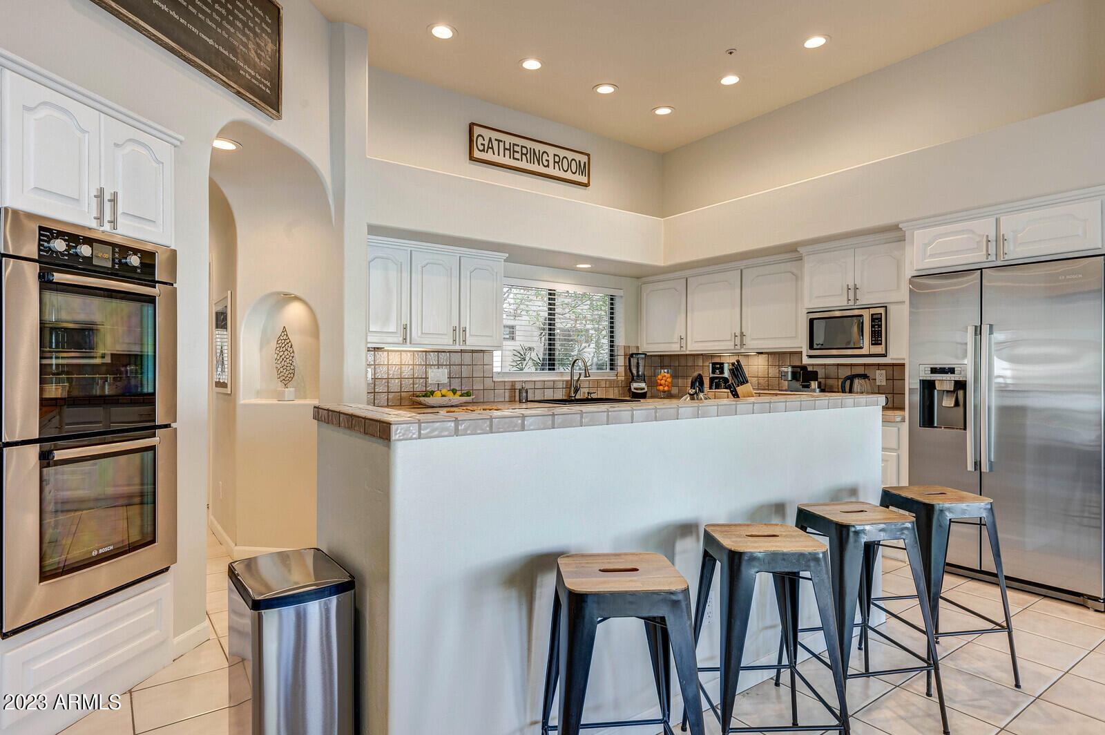 8161 East Alameda Road Scottsdale, AZ 85255 - Photo 22 of 107 a kitchen with stainless steel appliances granite countertop a refrigerator and a stove top oven with white cabinets