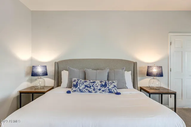 a view of a patio with table and chairs and floor to ceiling window