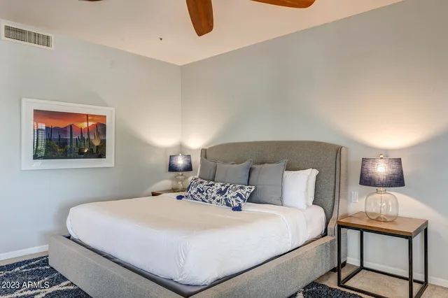 a front view of a house with a yard and potted plants