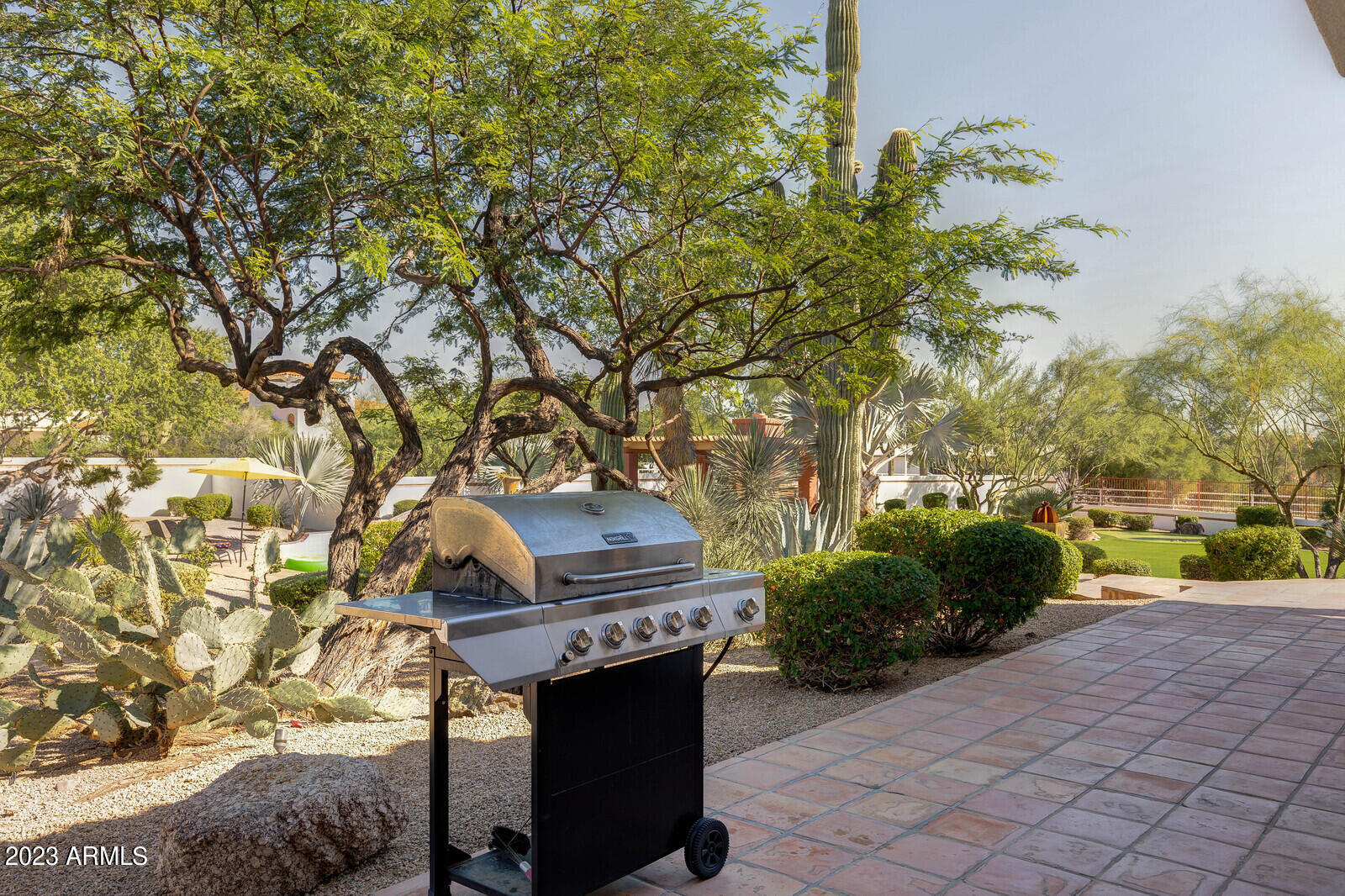 8161 East Alameda Road Scottsdale, AZ 85255 - Photo 62 of 107 a front view of a house with a yard and potted plants