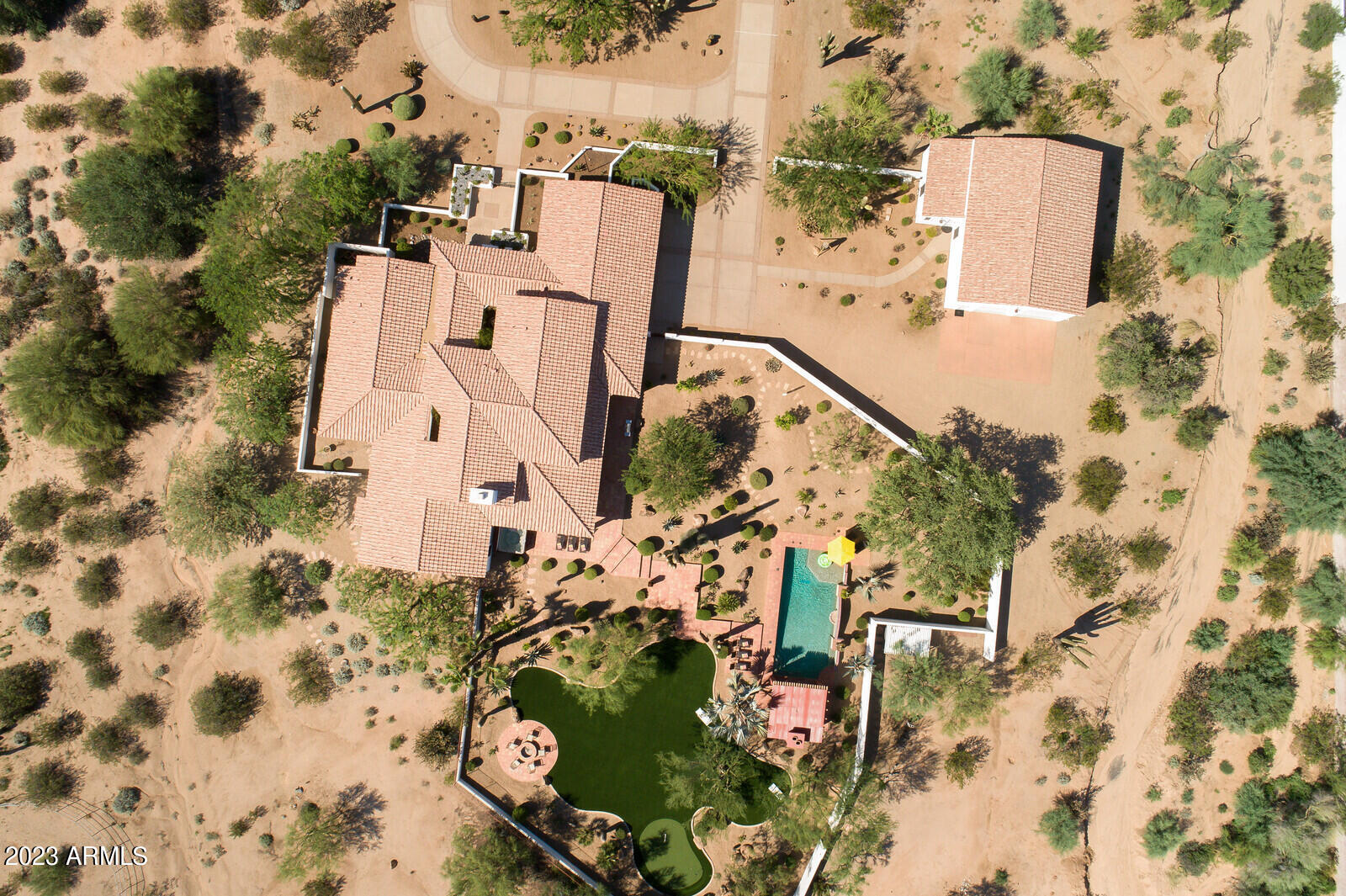 8161 East Alameda Road Scottsdale, AZ 85255 - Photo 98 of 107 an aerial view of a house with a yard and trees
