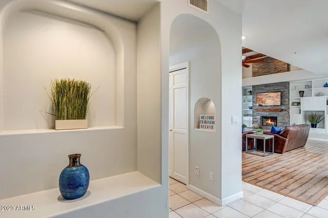 a kitchen with cabinets and chairs