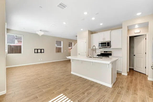 a kitchen with stainless steel appliances a refrigerator sink and microwave