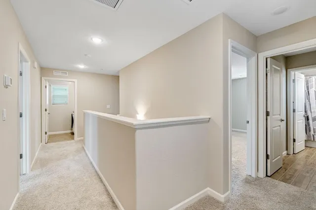 a view of a hallway with wooden shelves