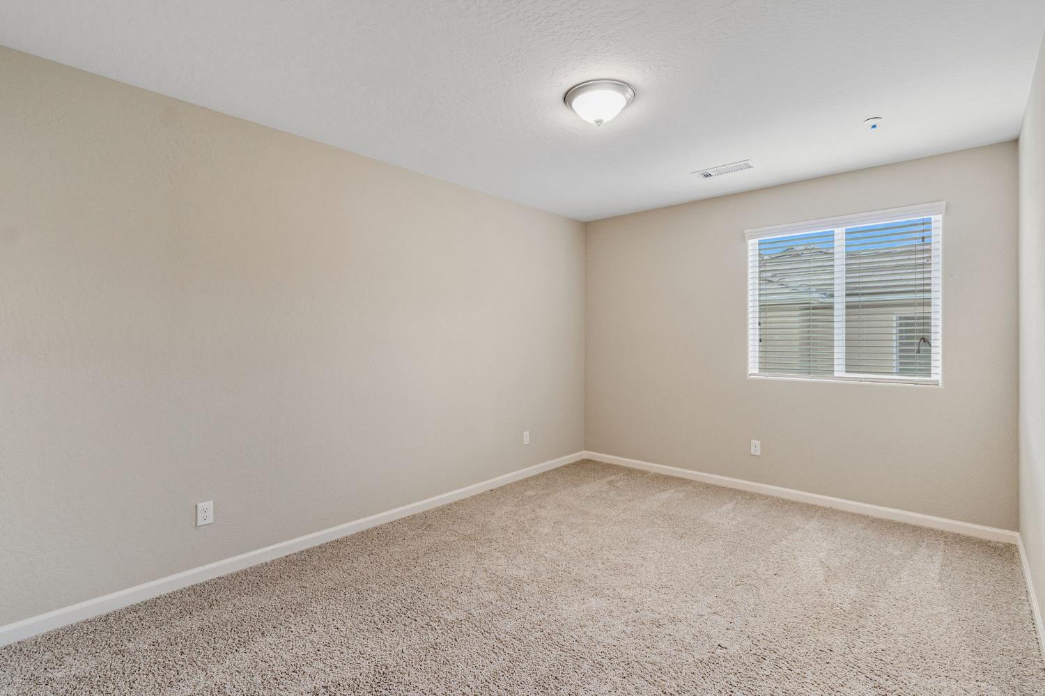 1116 Encore Way West Madera, CA 93636 - Photo 18 of 35 an empty room with a window