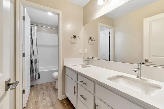 a bathroom with a sink a mirror and a shower