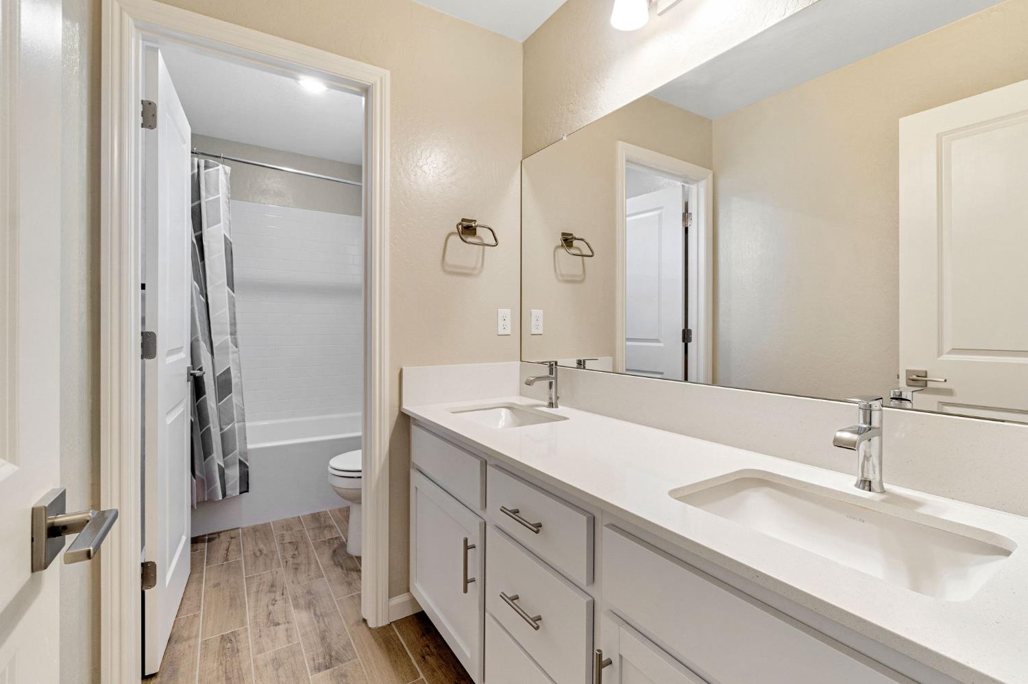 1116 Encore Way West Madera, CA 93636 - Photo 20 of 35 a bathroom with a sink a mirror and a shower