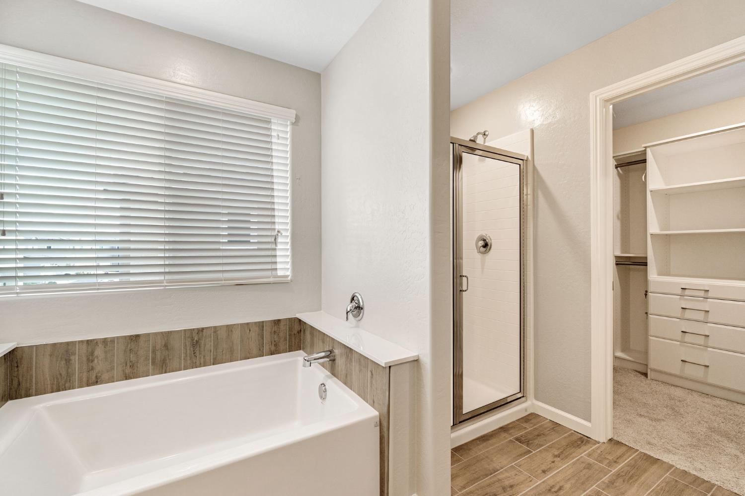 1116 Encore Way West Madera, CA 93636 - Photo 27 of 35 a bathroom with a bathtub and a shower