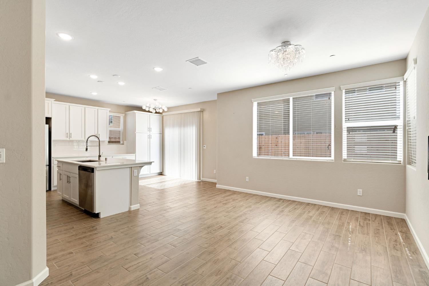 1116 Encore Way West Madera, CA 93636 - Photo 9 of 35 a view of a kitchen with a sink wooden floor and a window