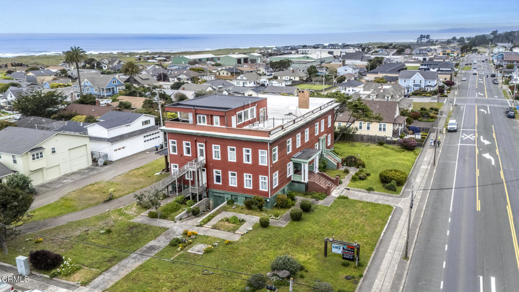 an aerial view of multiple houses with yard