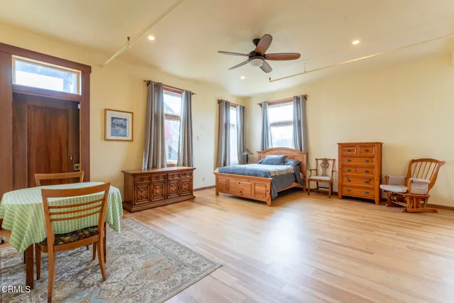 a spacious bedroom with a bed couch and a window