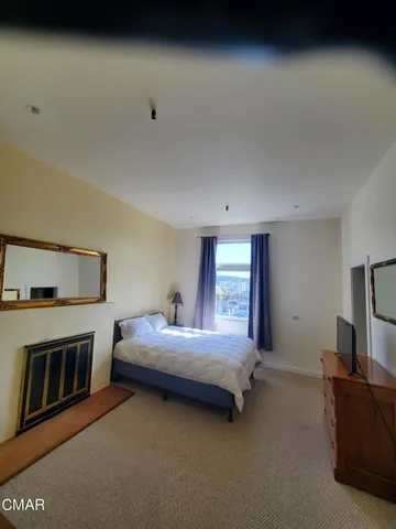 a bedroom with a bed and a ceiling fan