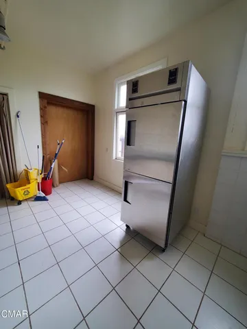 a view of kitchen with stainless steel appliances wooden cabinets and a counter top space