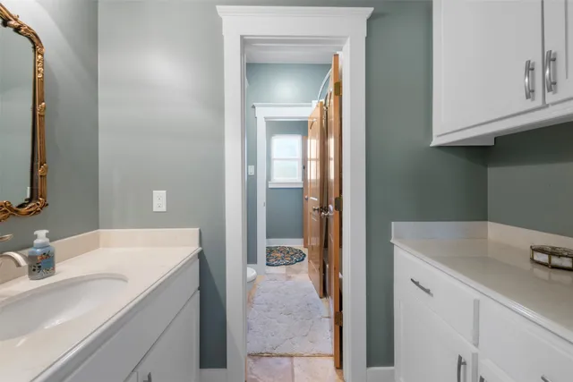 a en suite bathroom with a sink and a mirror