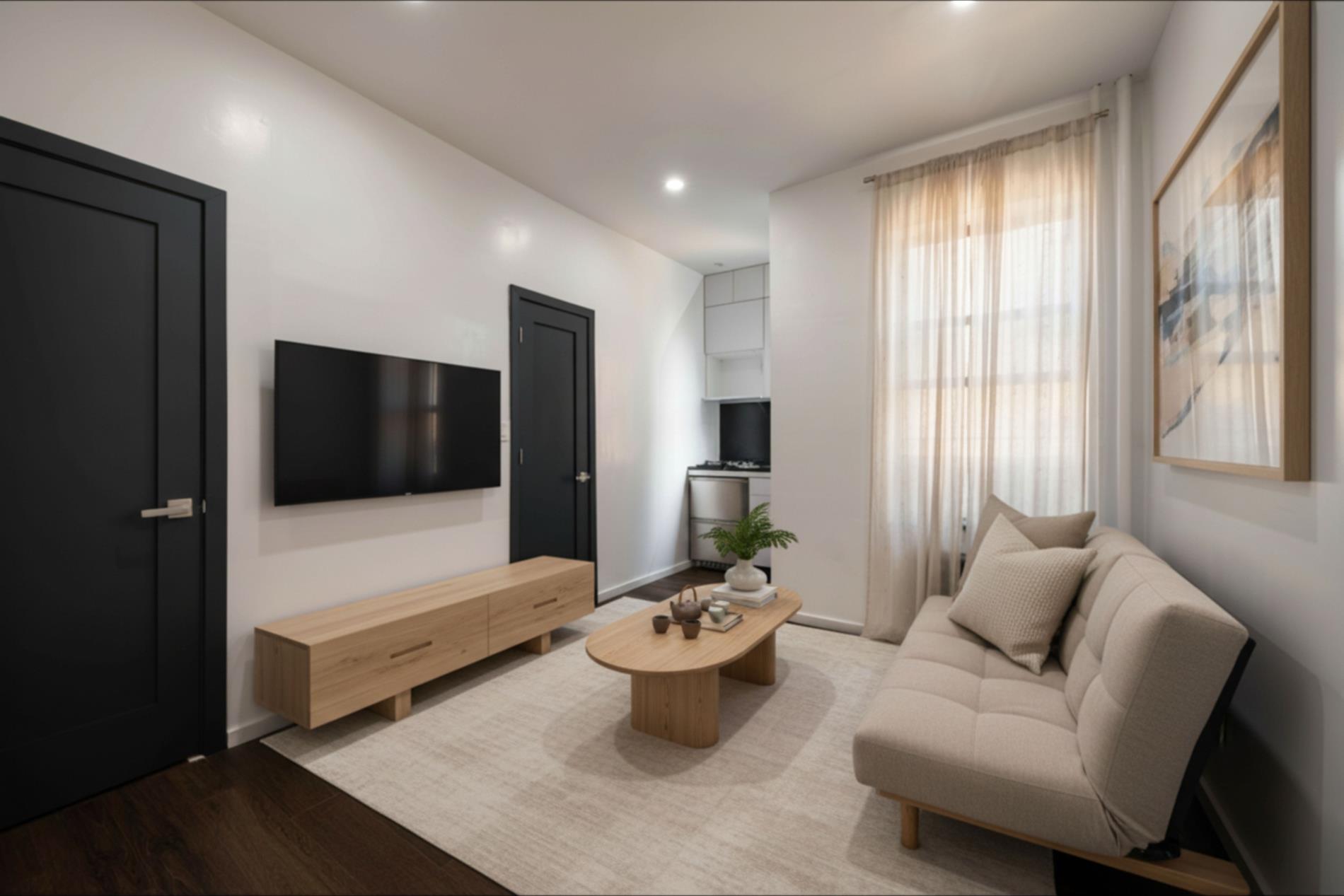 96 Perry Street, Unit B17B Manhattan, NY 10014 - Photo 1 of 8 a living room with furniture and a flat screen tv