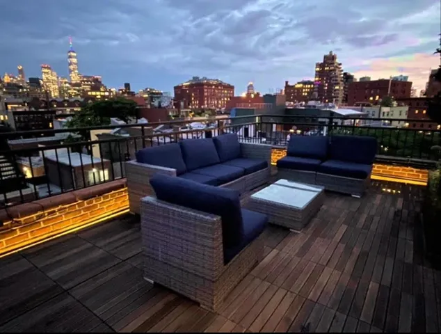 a view of a backyard with sitting area