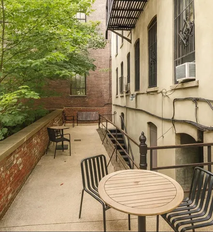 a view of a rooftop deck with couch and a potted plant