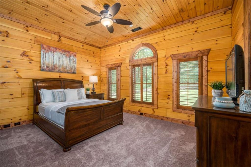 31 High Cliff Road Jasper, GA 30143 - Photo 20 of 23 a spacious bedroom with a bed and a chandelier