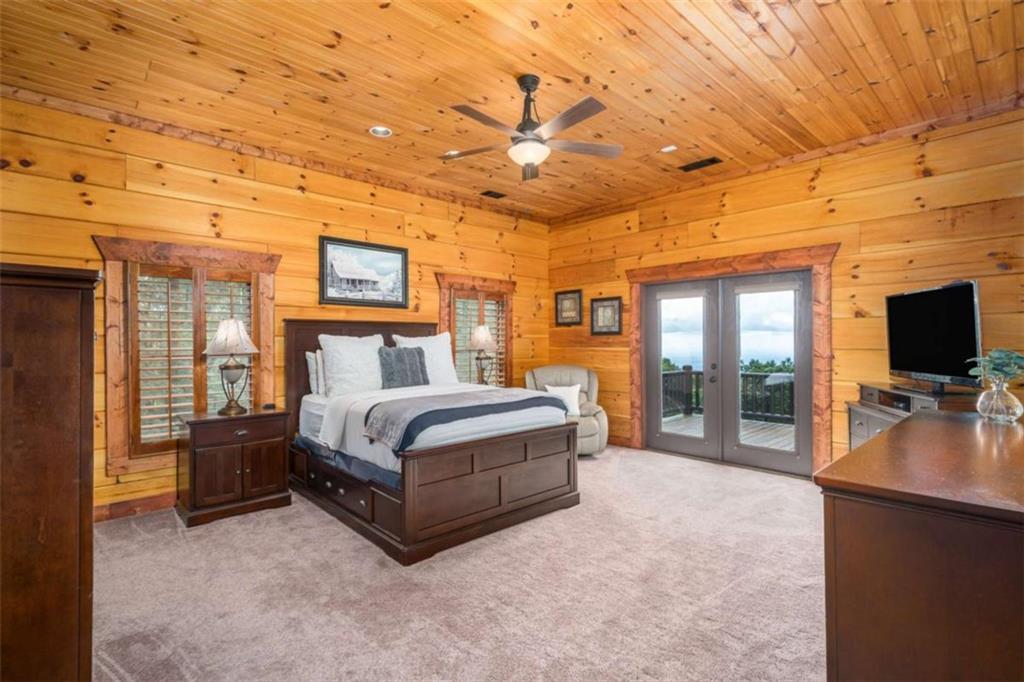 31 High Cliff Road Jasper, GA 30143 - Photo 6 of 23 a spacious bedroom with a bed and wooden floor