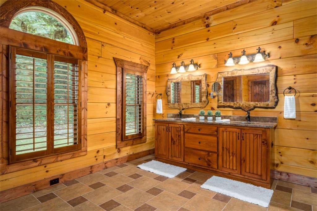 31 High Cliff Road Jasper, GA 30143 - Photo 7 of 23 a bathroom with a sink a mirror and next to a window