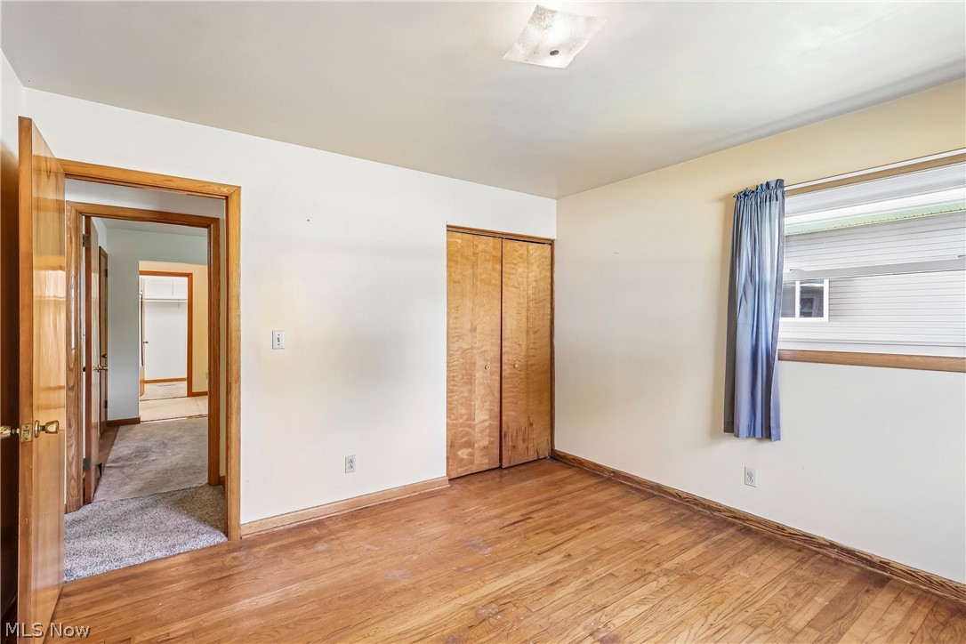 2758 Shellhart Road Norton, OH 44203 - Photo 24 of 41 Bedroom with closet and wood flooring