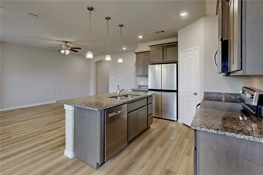 2010 Chief Street Bryan, TX 77807 - Photo 17 of 29 a kitchen with stainless steel appliances granite countertop a refrigerator a stove and a sink