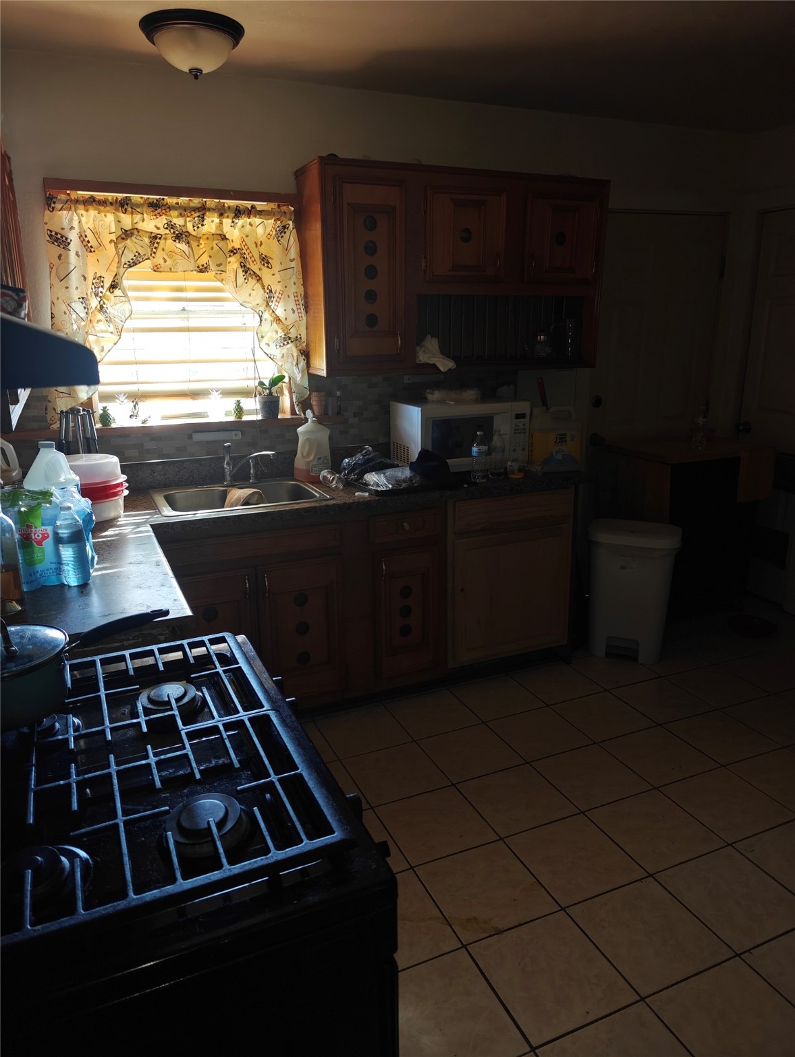 5874 Westover Street Houston, TX 77033 - Photo 7 of 7 a kitchen with sink a stove and cabinets