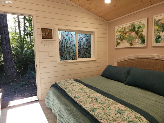 a bedroom with a bed and a window