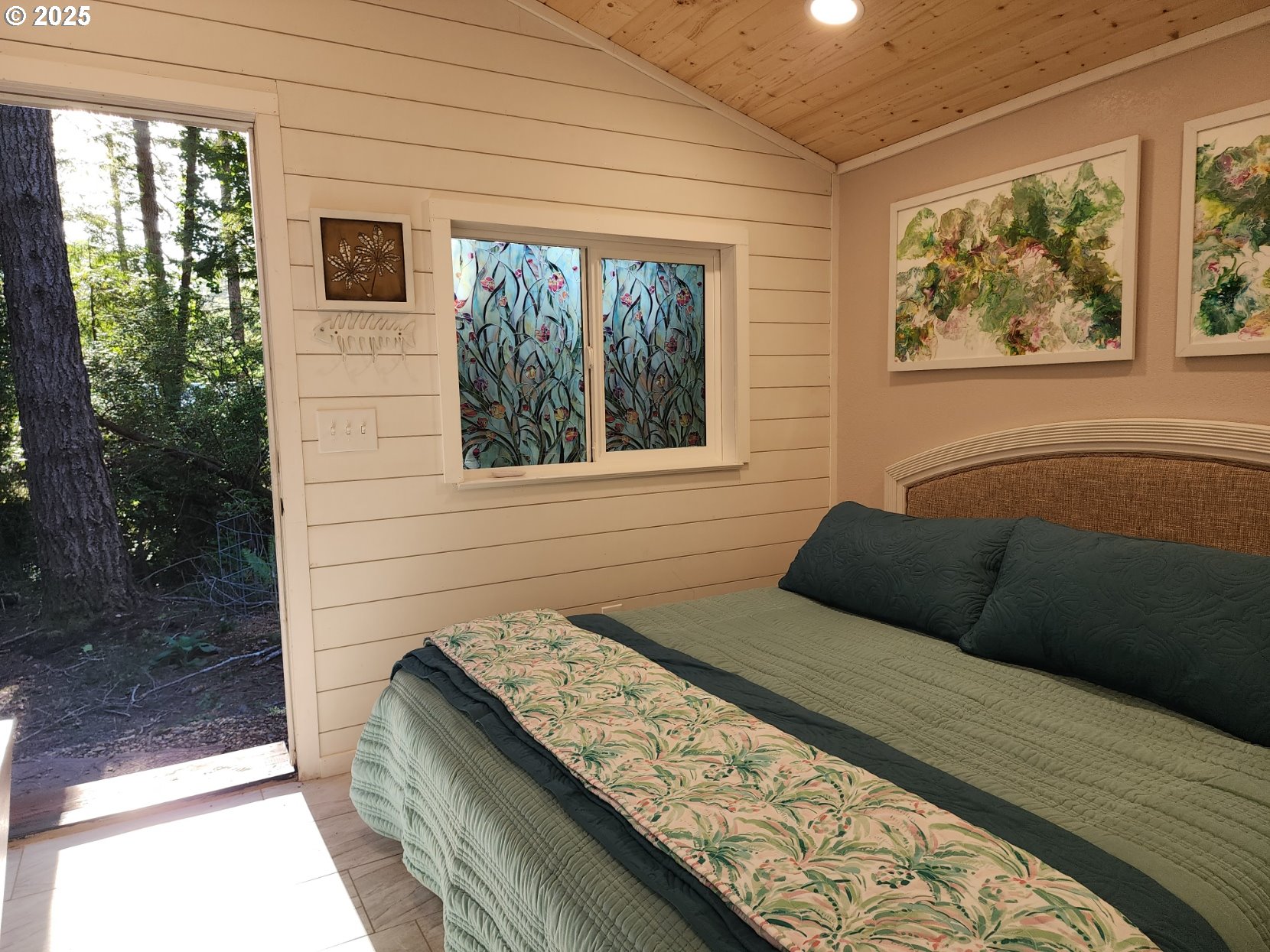 Orchard Road, Unit 3 Port Orford, OR 97465 - Photo 15 of 32 a bedroom with a bed and a window