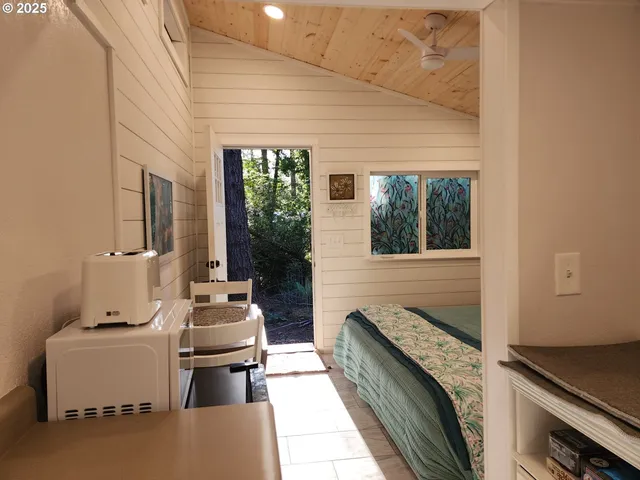 a kitchen with furniture and large windows