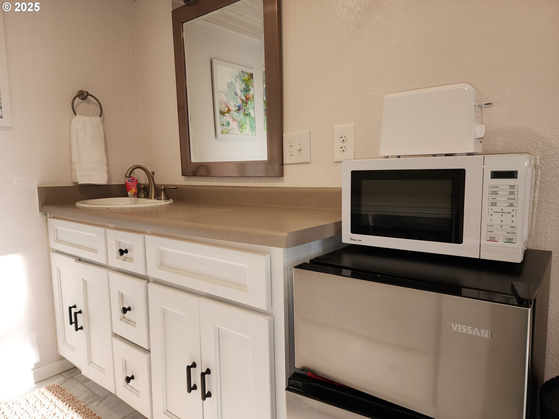 Orchard Road, Unit 3 Port Orford, OR 97465 - Photo 18 of 32 a kitchen with white cabinets and sink