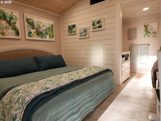 a bedroom with a bed and wall painting