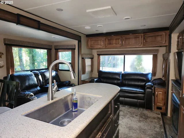 a kitchen with large windows and a sink