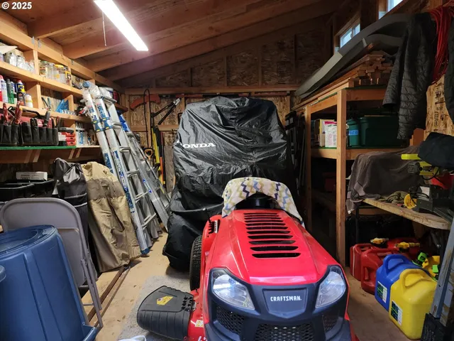 a utility room with lots of clutter and furniture